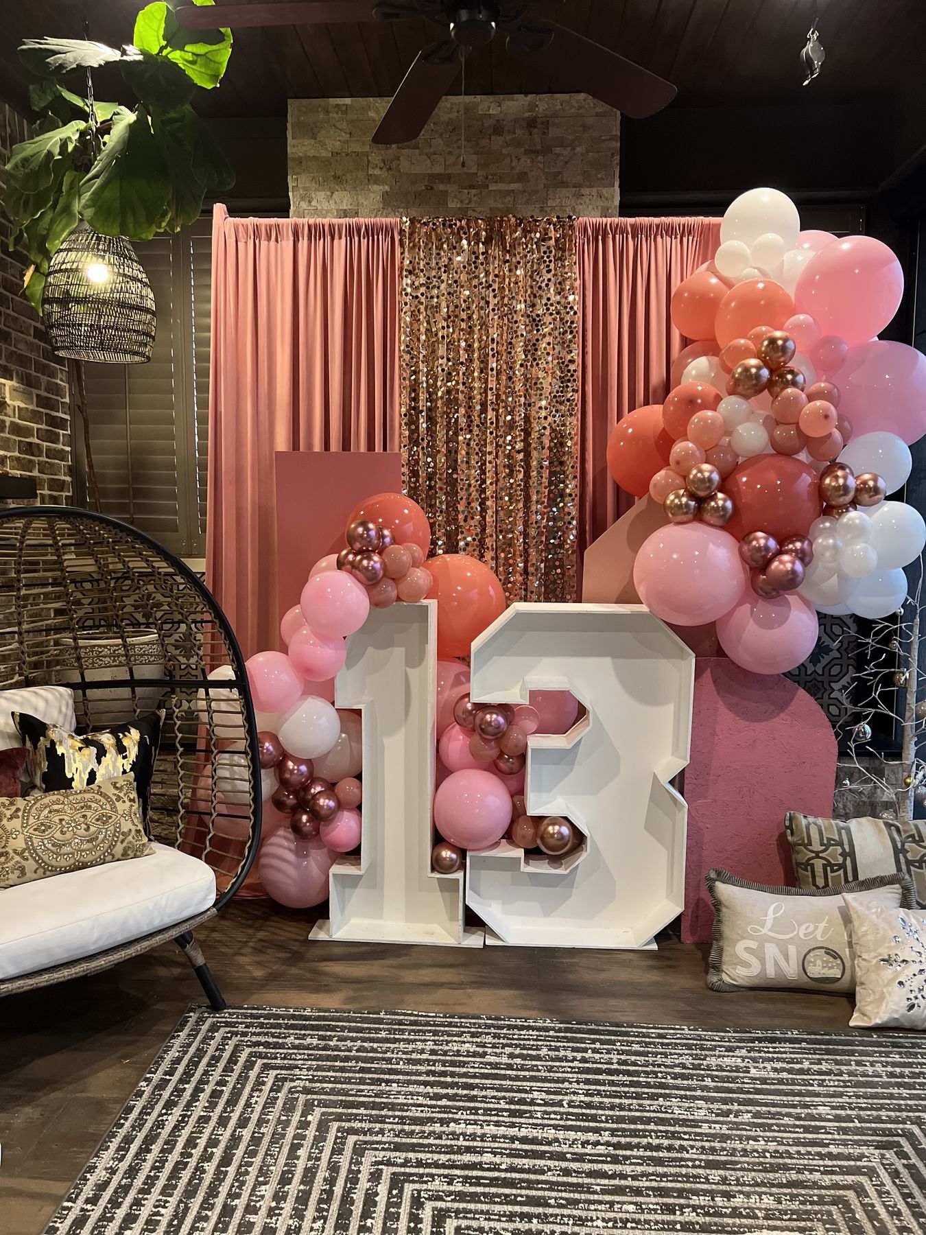 Balloon installation above a styled birthday table