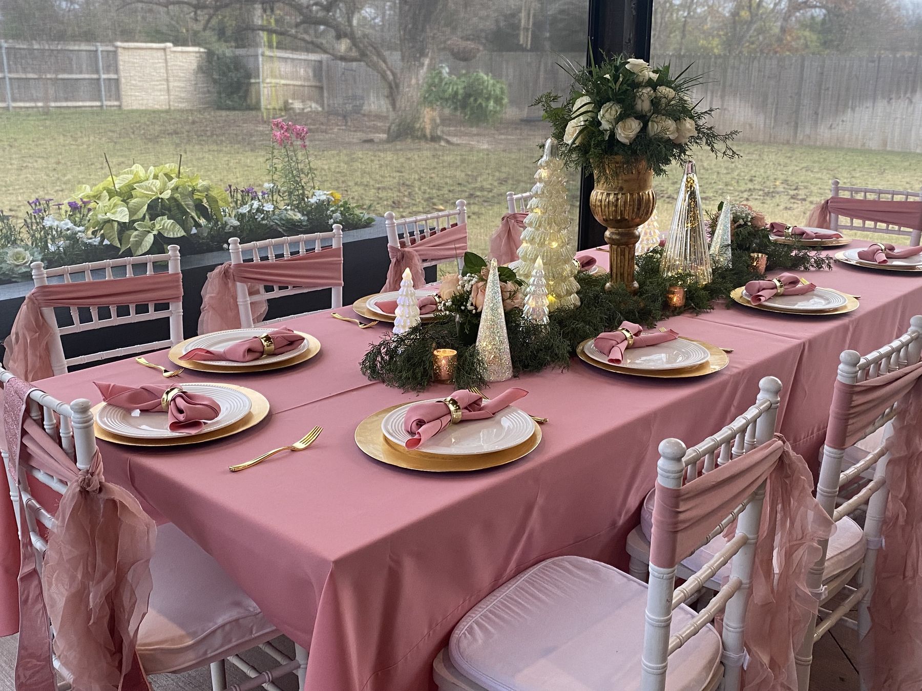 Long garden table set with pink linens and florals